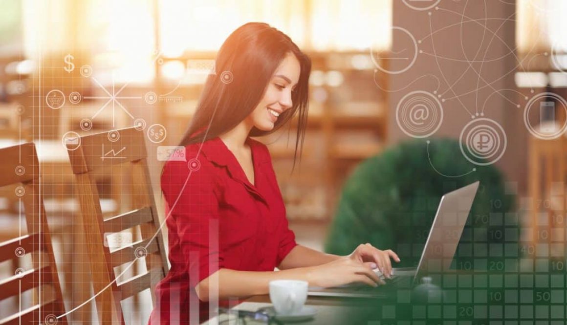 Young business woman uses laptop in cafe